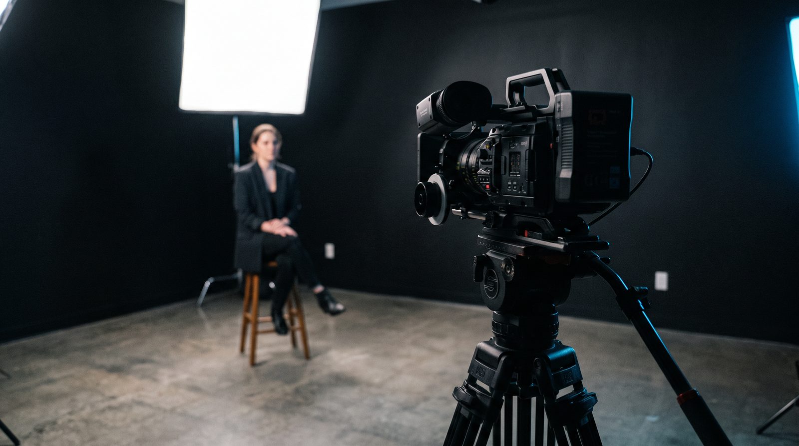 Cinema camera on a tripod in a dark studio