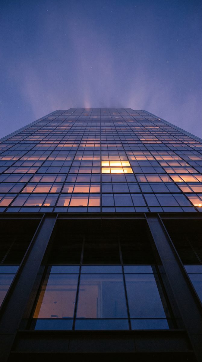 Glass office tower at dusk